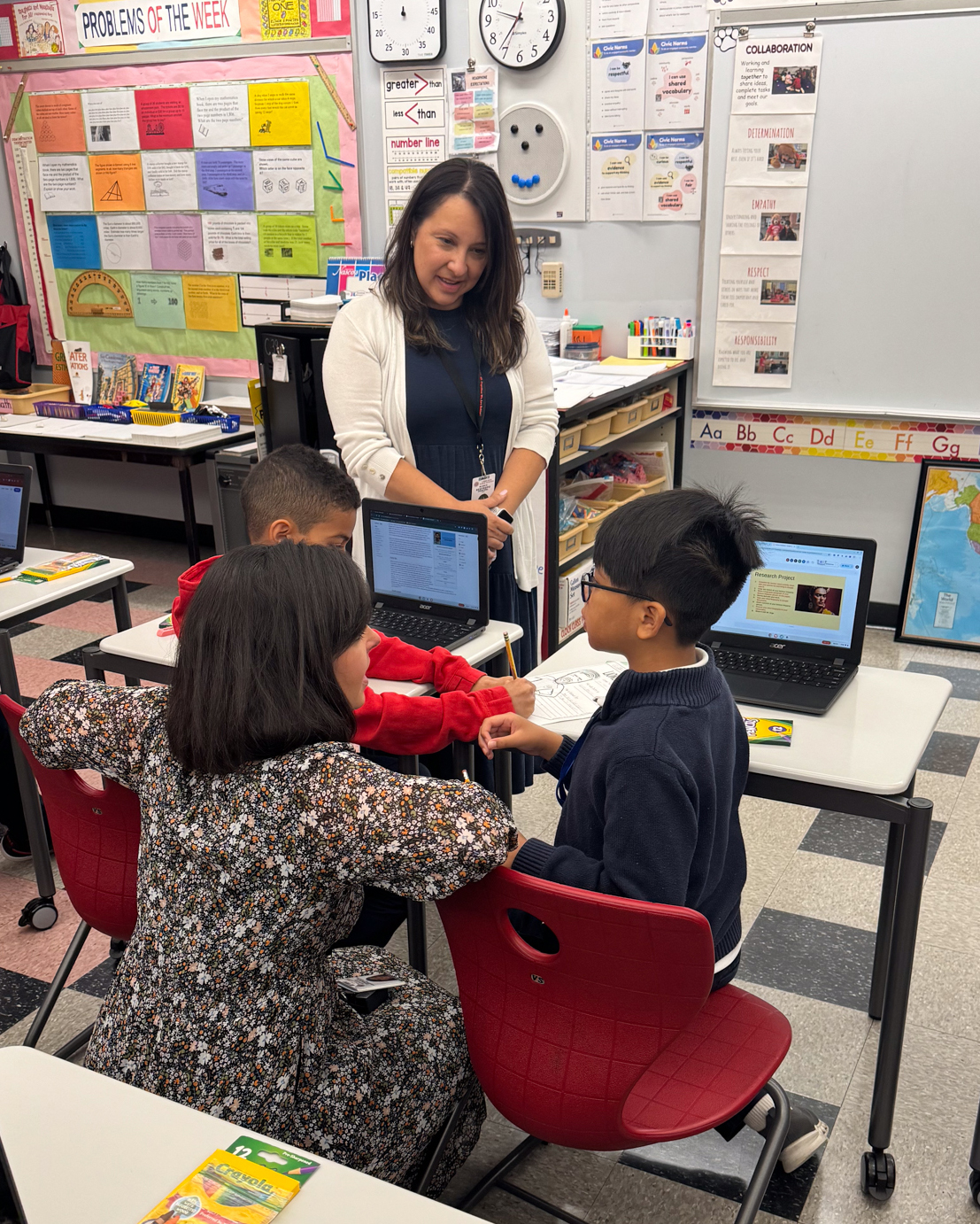 Berkowitz administrators working with students in classroom
