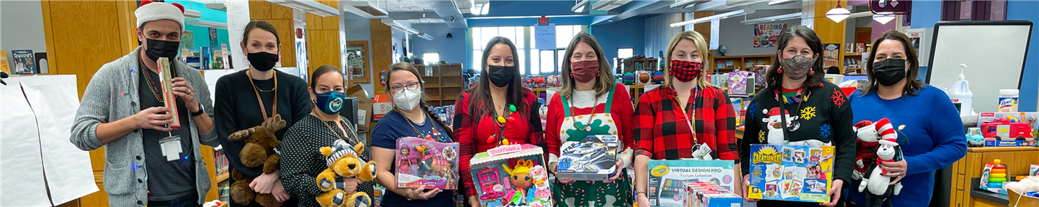 Members of the MCB Holiday Shop Committee posed with toys and items that were available for parents at the MCB Complex