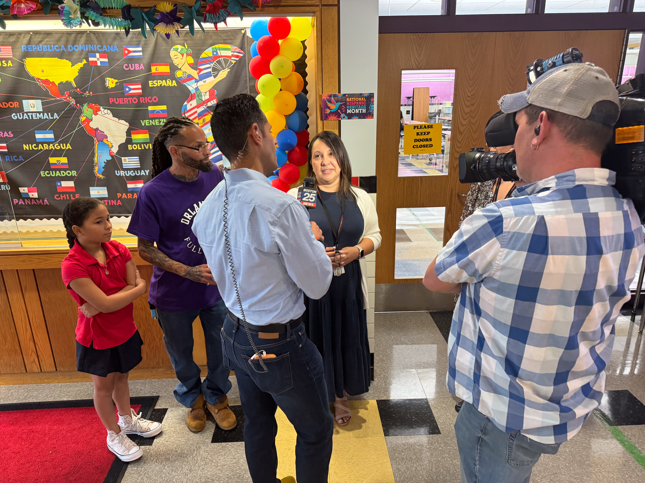 Principal Blanca Restrepo speaking with Boston 25 News in the Berkowitz School lobby