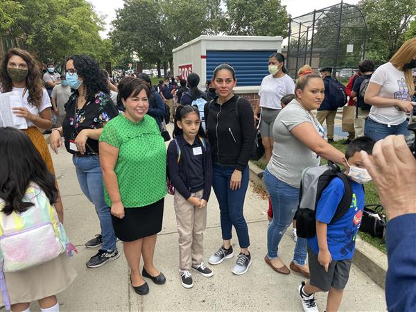 Superintendent Dr. Almi G. Abeyta took a photograph with a student and her mother outside the Mary C. Burke Elementary Complex.