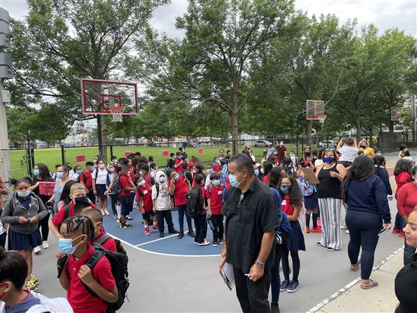 Students gathered outside the Mary C. Burke Elementary Complex to begin their first day of school. 