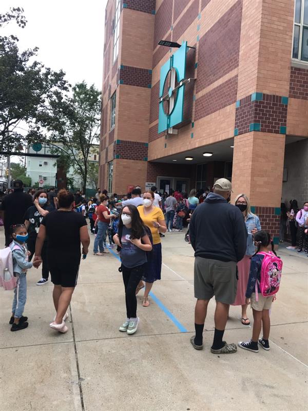Students gathered outside the Mary C. Burke Elementary Complex to begin their first day of school. 