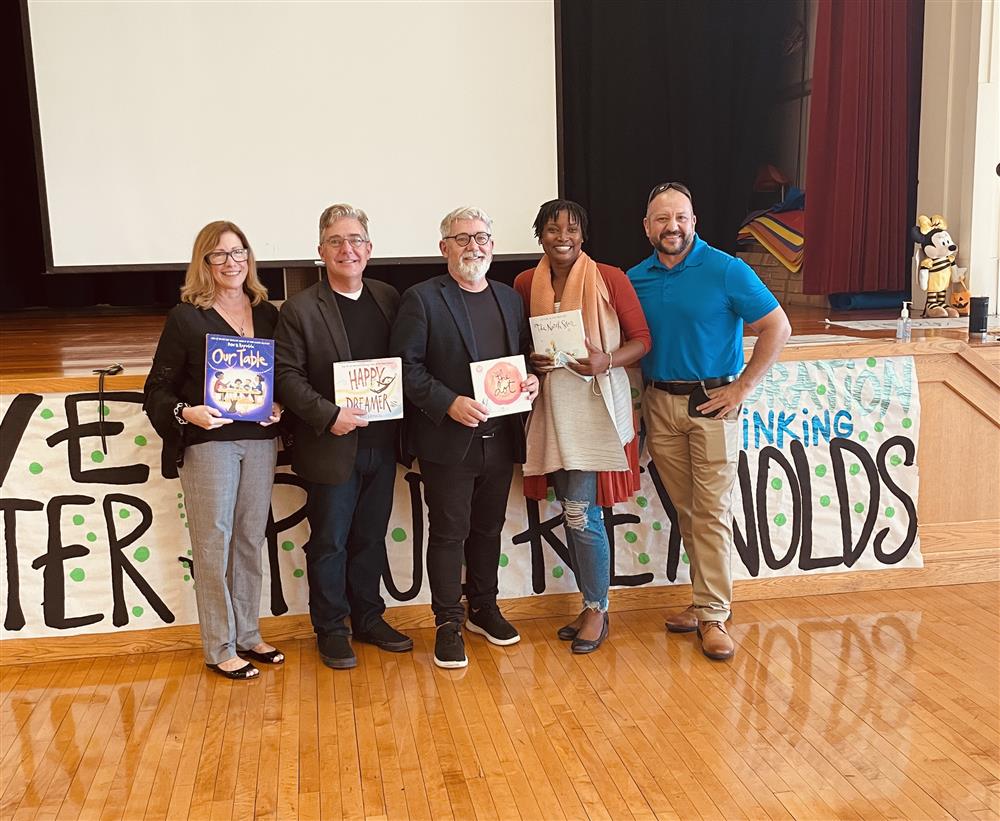 Staff members of Chelsea Public Schools and the Early Learning Center posed for a picture with Peter and Paul Reynolds.