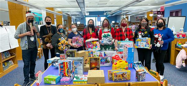 Left to right: Mary C. Burke Complex Family Holiday Shop Committee Johnny Giraldo, Meghan D'arcy, Vivian Quiles, Julie Forry, Yolanda Vallés, Jennifer Dobbins, Laura Hubert, Sharon Romeo and Alexa Mejia Fernandez.