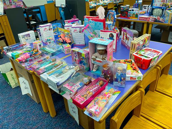 Toys available to parents and families at the Holiday Shop including barbies, Frozen toys, and more like these!